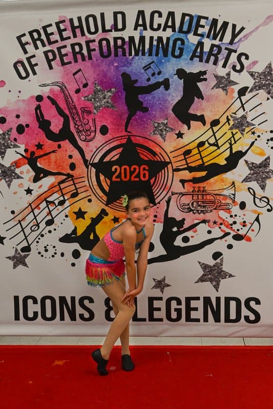 A dancer in a rainbow costume