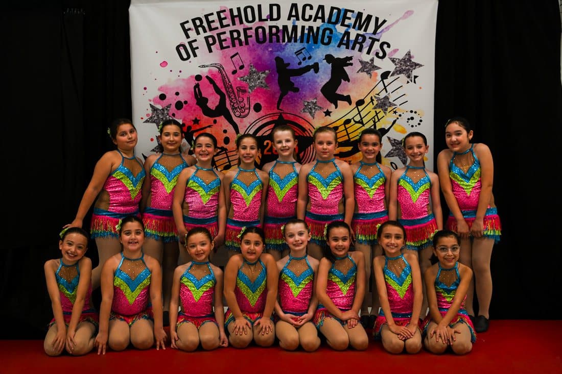 A class in rainbow-striped costumes