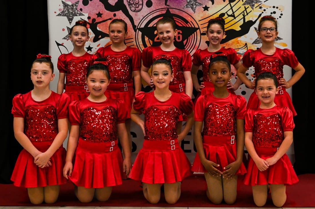 A class in red sequin costumes